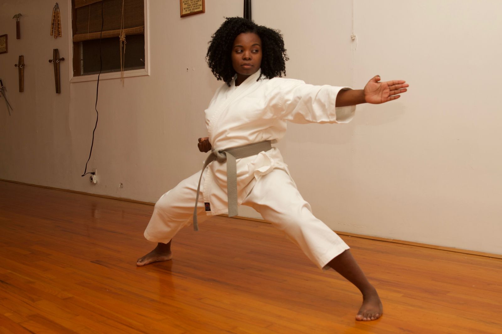Student in a strong, wide fighting stance on the dojo floor