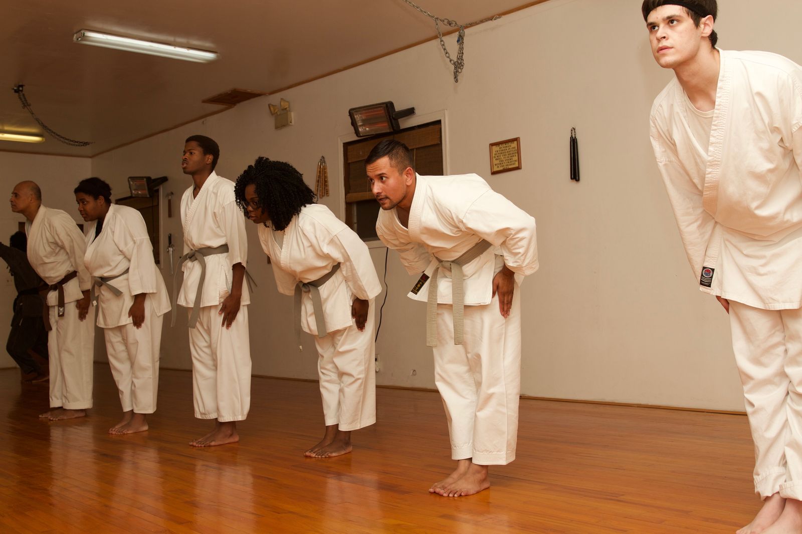 Students bowing together at the close of a training session